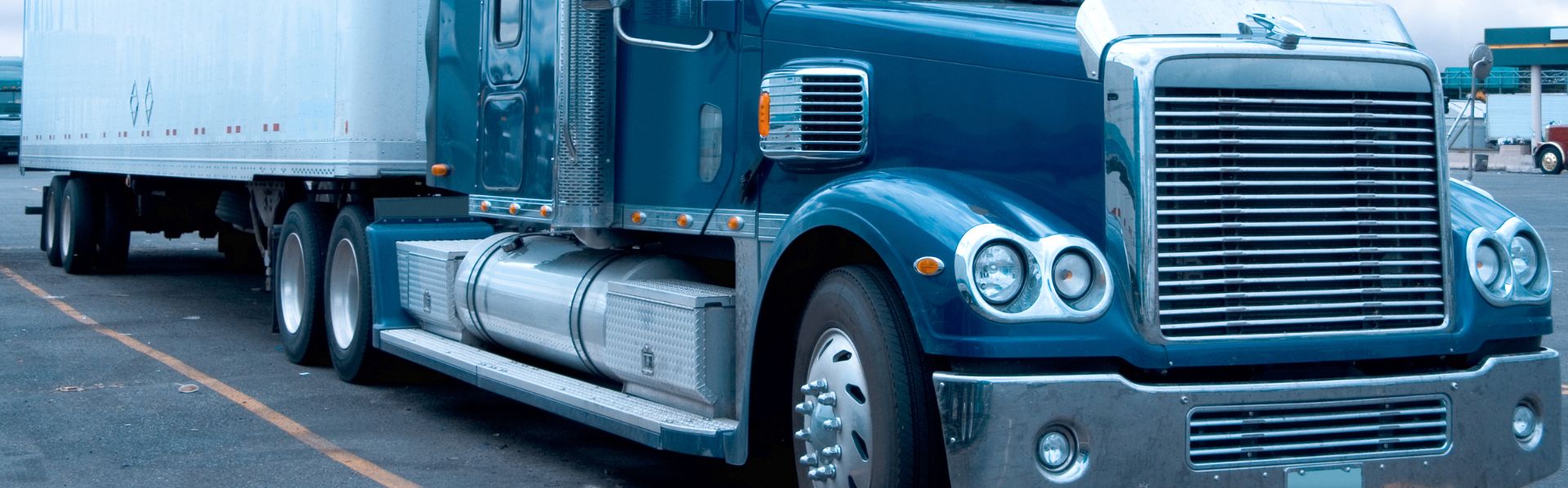blue tractor trailer truck parked