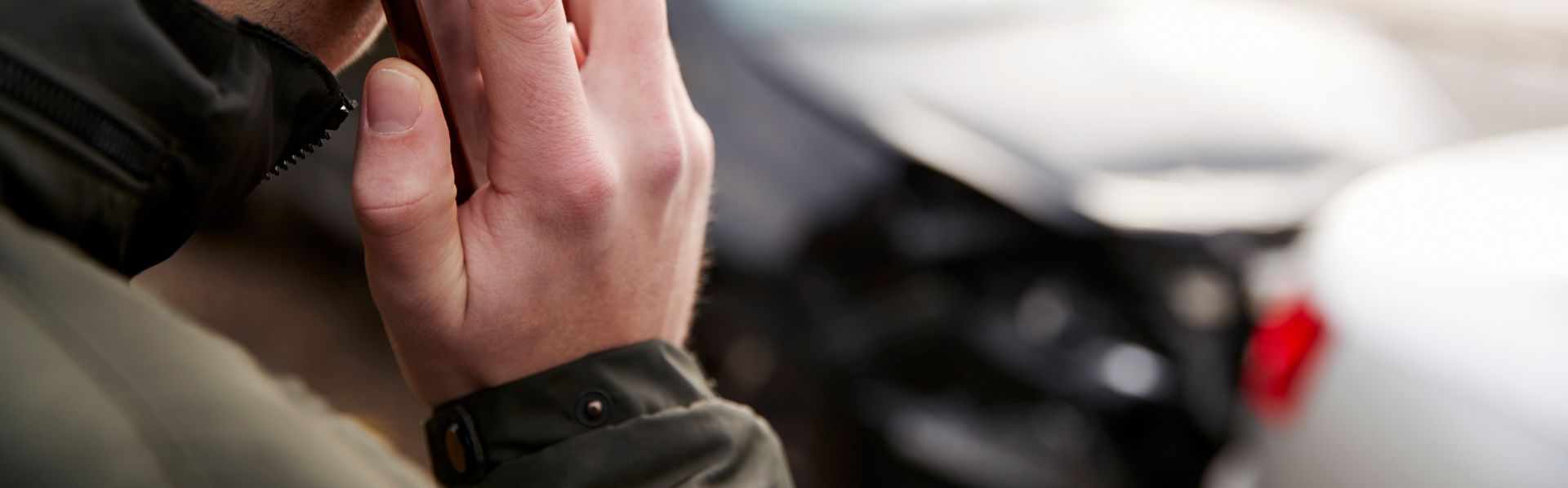 man calling the police after a car accident