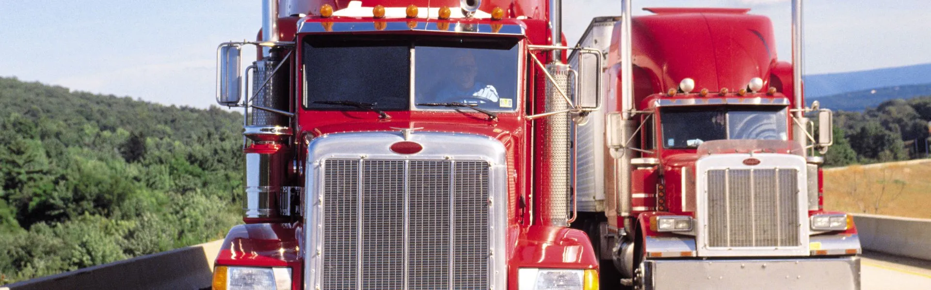Two trucks driving down a highway